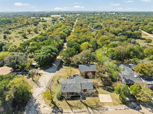an aerial view of a house with a yard