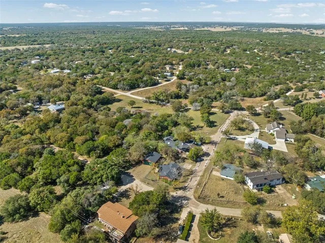 an aerial view of a house with a yard swimming pool and outdoor seating