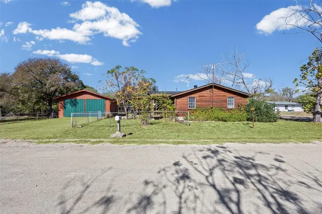 a backyard of a house with a yard and plants