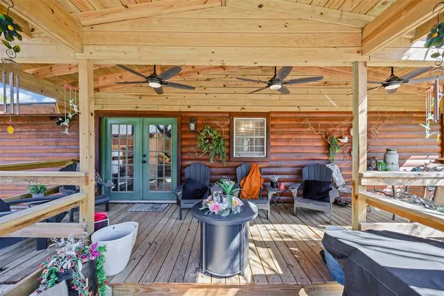 a view of a patio with chairs and potted plants