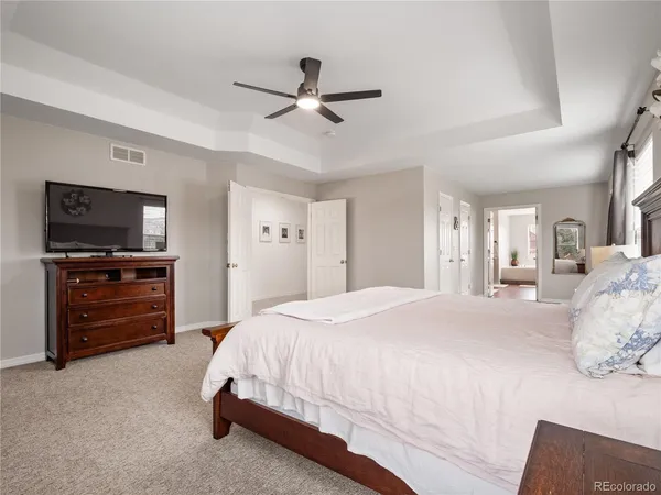 a bedroom with a bed and a television