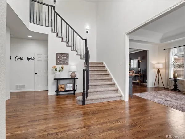 a view of entryway and hall with wooden floor