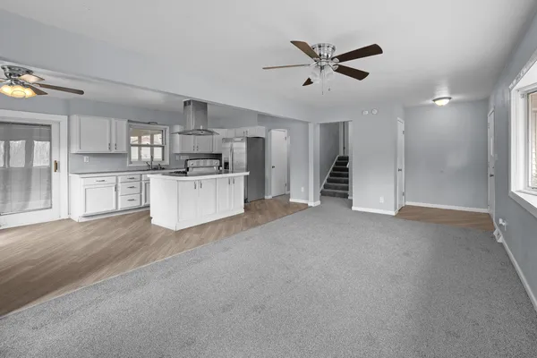 a view of a kitchen with a sink and a refrigerator