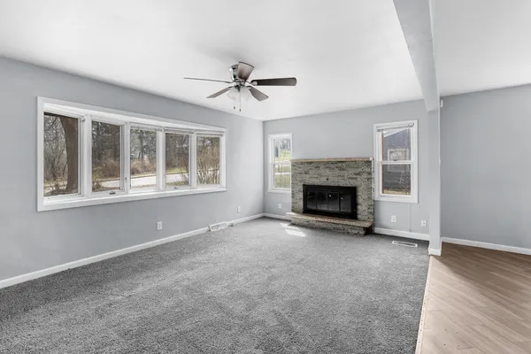 a view of empty room with a fireplace