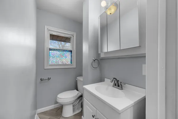 a bathroom with a toilet sink and mirror