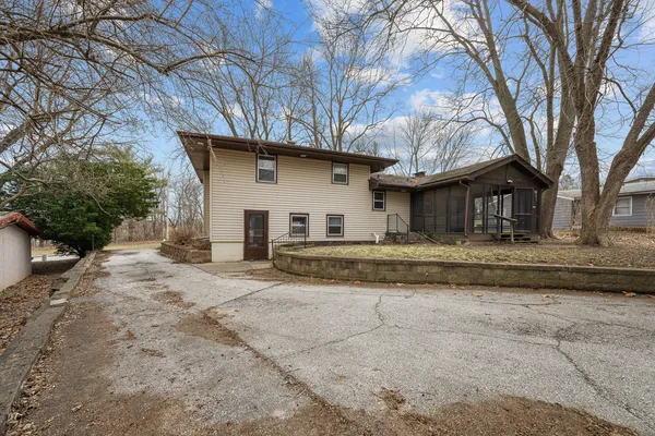a house that has a tree in front of it