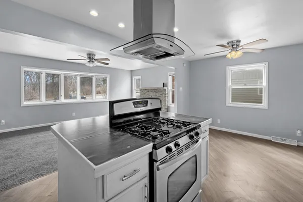 a kitchen with stainless steel appliances granite countertop a stove a sink and a granite counter tops