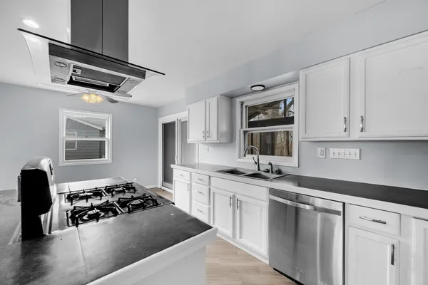 a kitchen with stainless steel appliances a sink and a stove