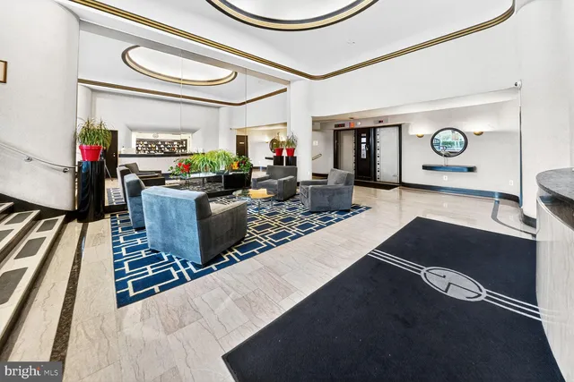 a lobby with furniture and floor to ceiling window