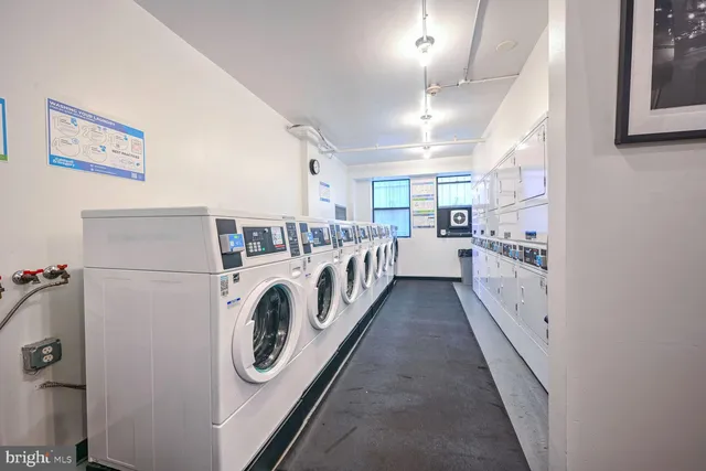 a view of a storage and utility room with washer and dryer