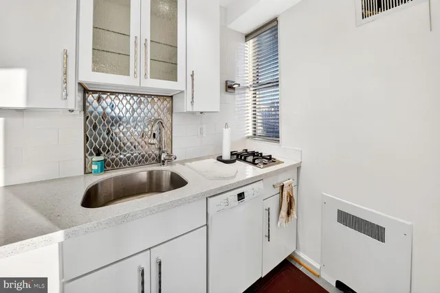 a kitchen with a sink and cabinets