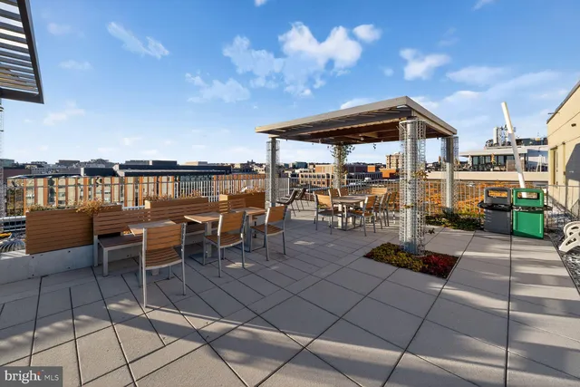 a view of a patio with dining table and chairs