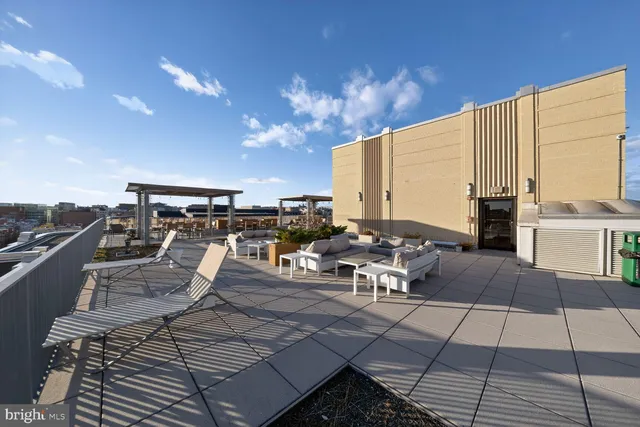 a view of a patio with a dining table and chairs with wooden floor