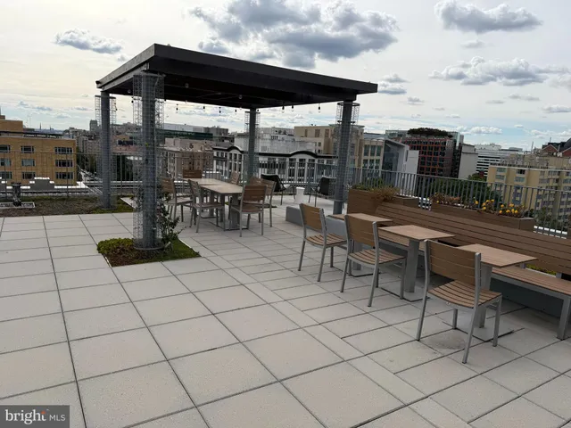 a view of a balcony with wooden chairs