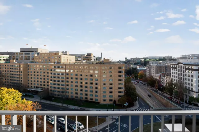a view of a tall building next to a road