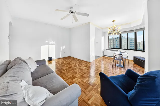 a view of a livingroom with wooden floor and a chandelier