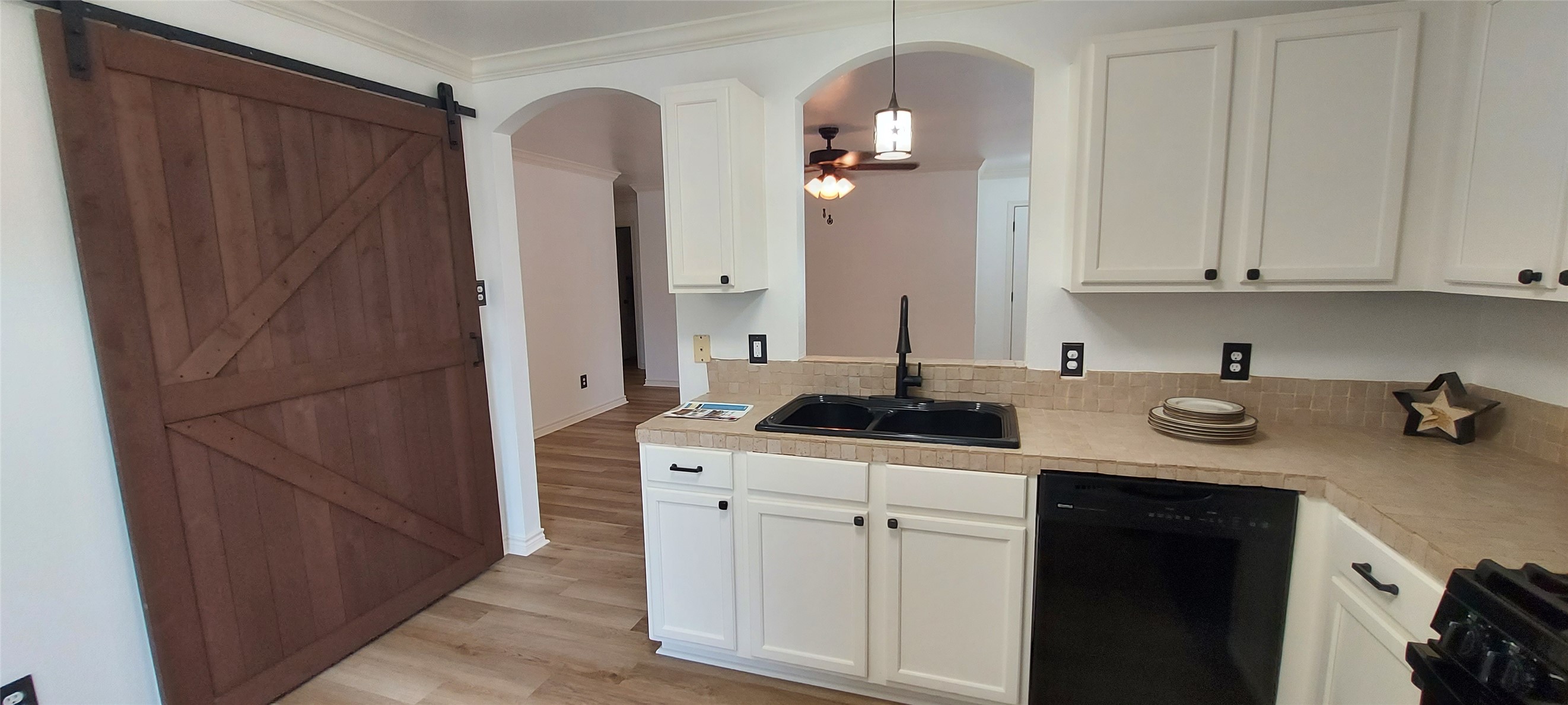 17609 Soapberry Cove Elgin, TX 78621 - Photo 11 of 38 a kitchen with stainless steel appliances granite countertop a refrigerator a sink and white cabinets