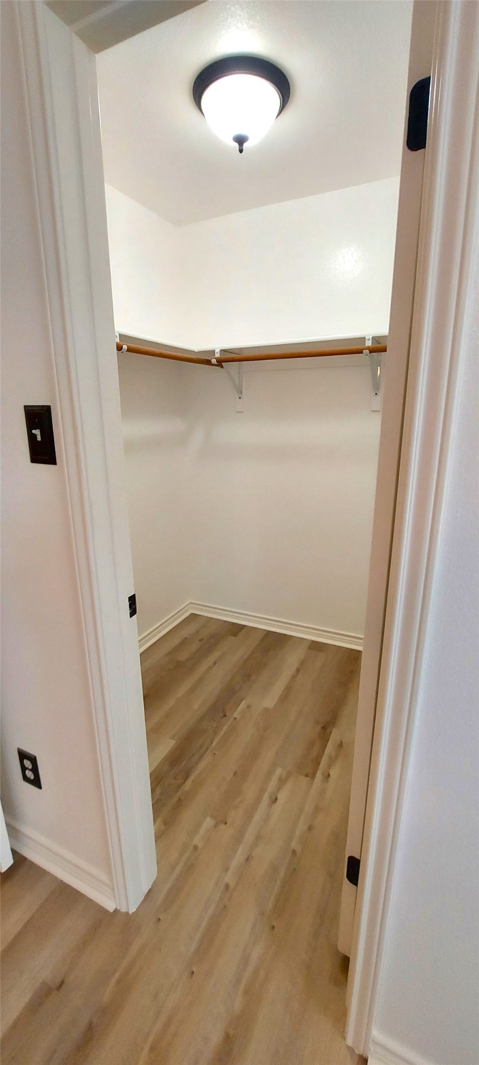 17609 Soapberry Cove Elgin, TX 78621 - Photo 19 of 38 an empty room with wooden floor and fan