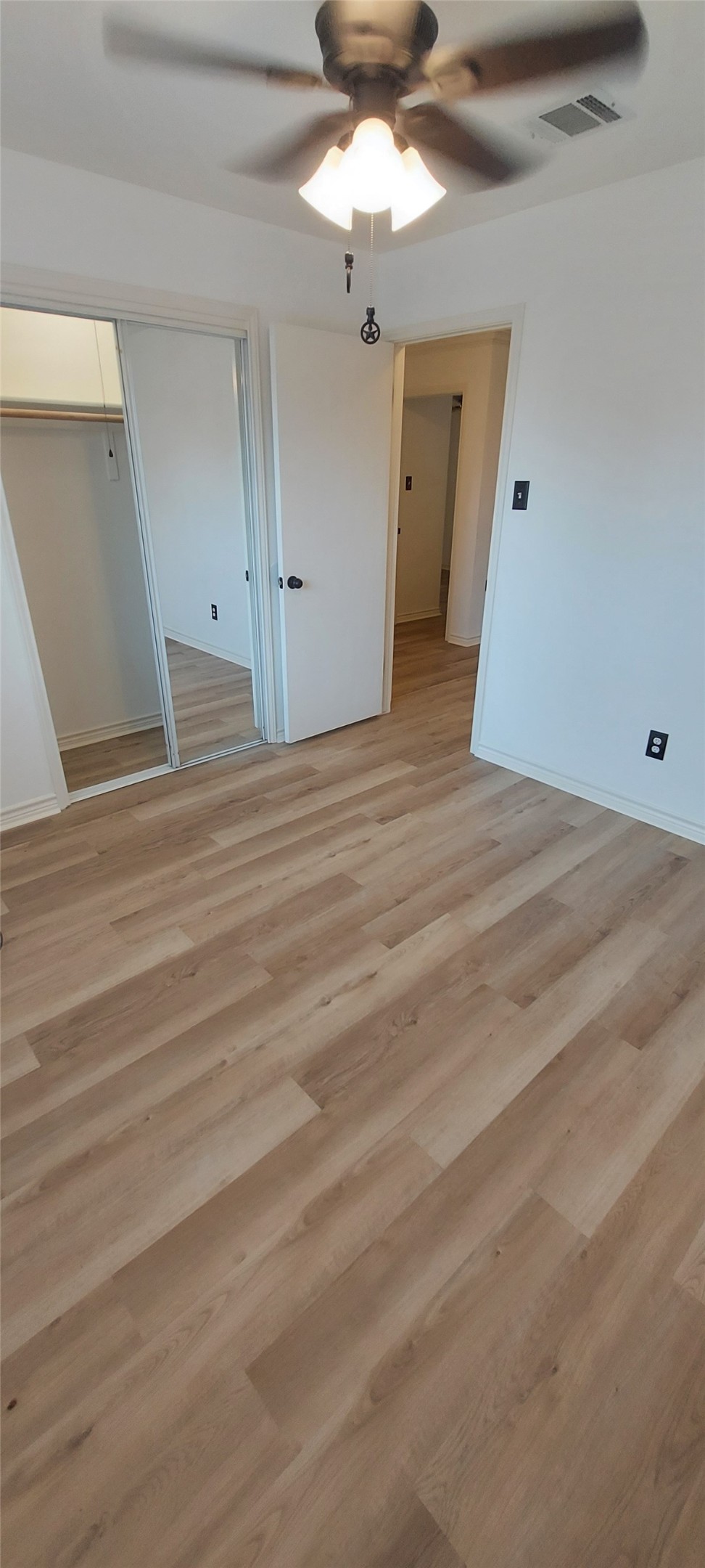 17609 Soapberry Cove Elgin, TX 78621 - Photo 25 of 38 en empty room with wooden floor and ceiling fan