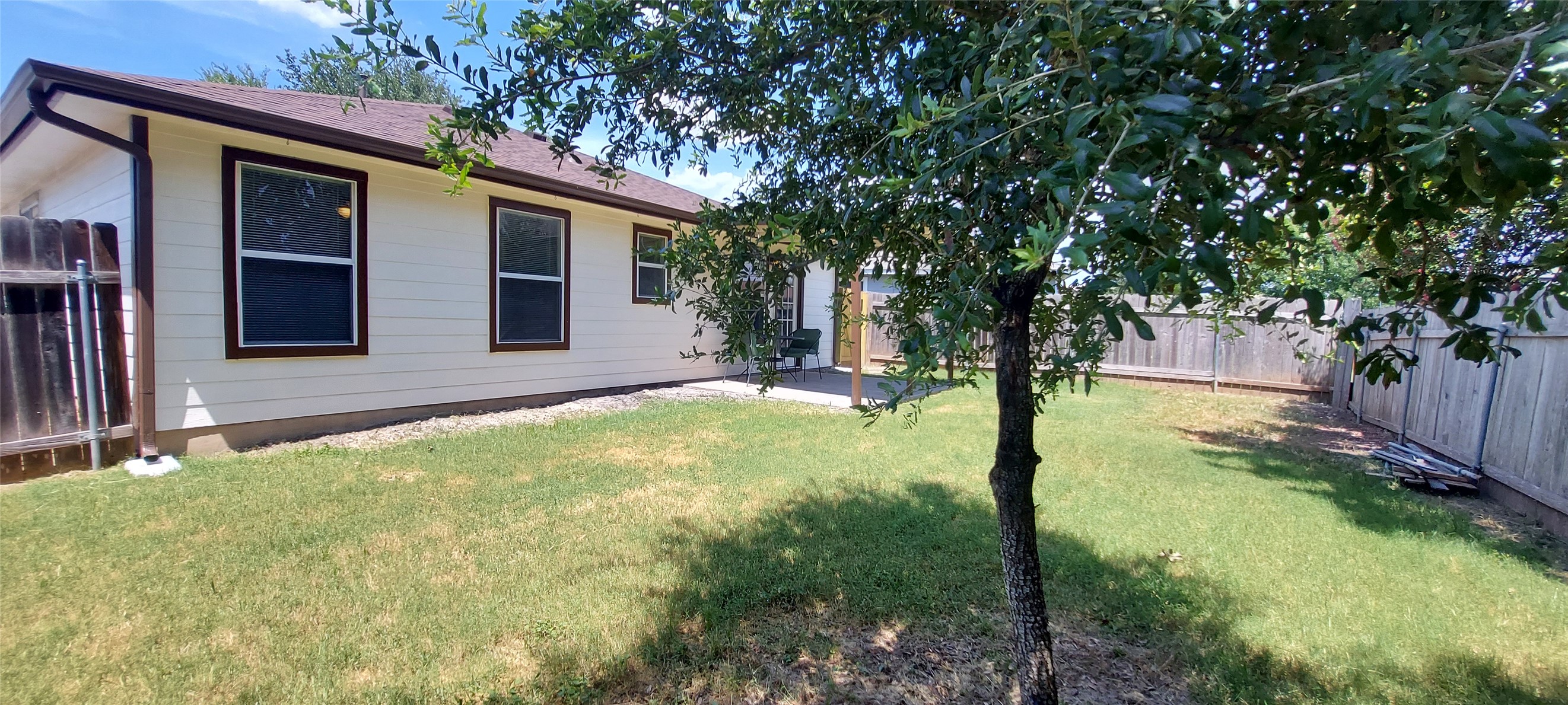 17609 Soapberry Cove Elgin, TX 78621 - Photo 30 of 38 a backyard of a house with yard and outdoor seating