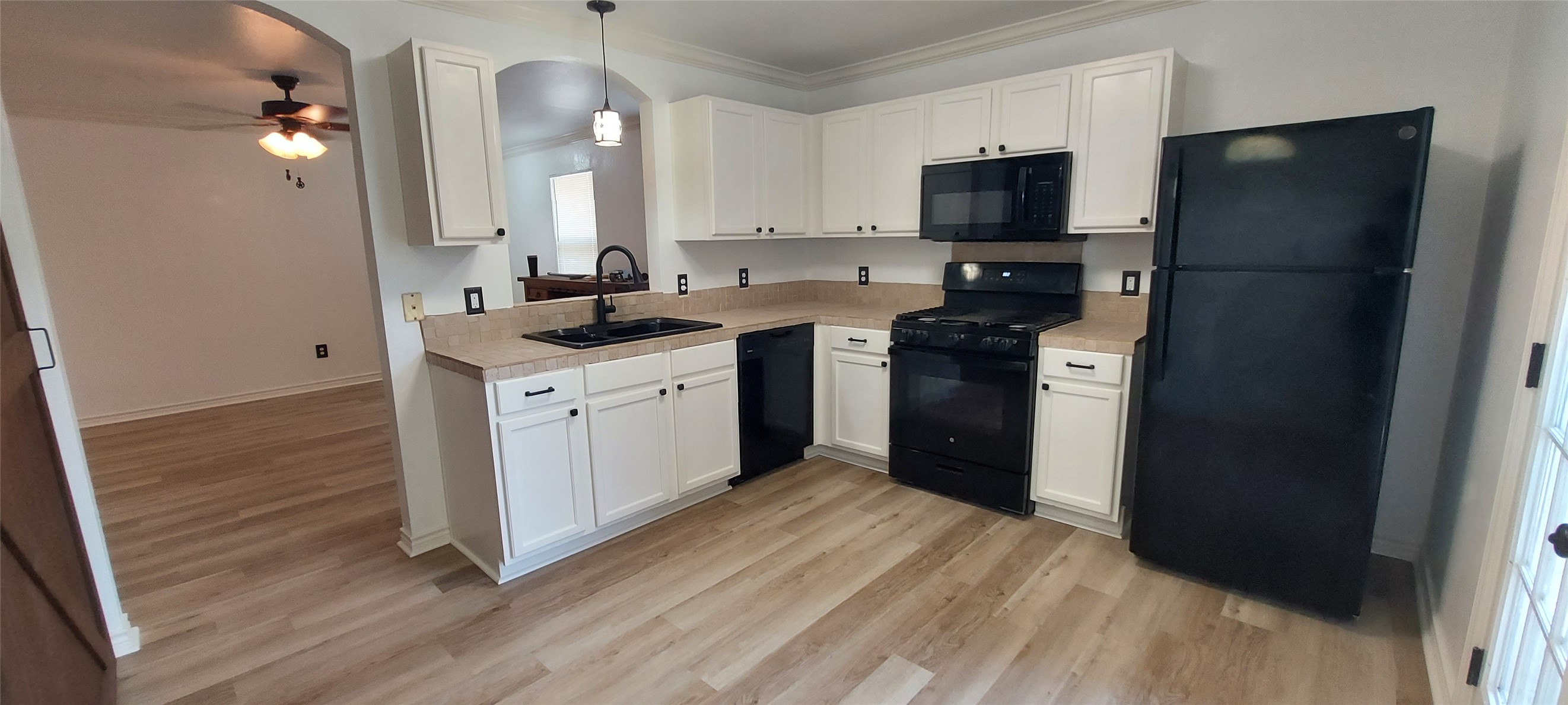 17609 Soapberry Cove Elgin, TX 78621 - Photo 6 of 38 a kitchen with stainless steel appliances granite countertop a refrigerator a stove a sink and a microwave