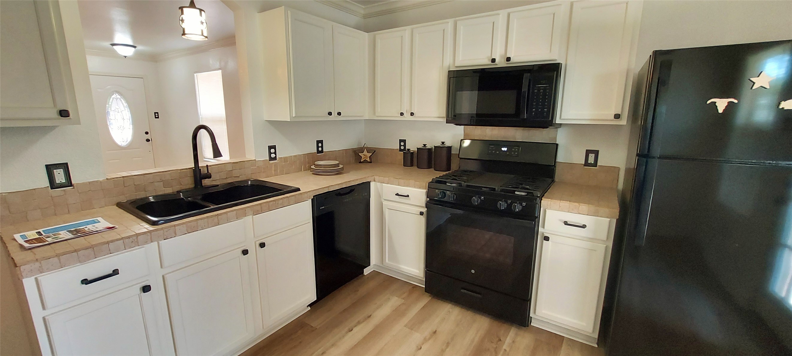 17609 Soapberry Cove Elgin, TX 78621 - Photo 8 of 38 a kitchen with stainless steel appliances granite countertop a sink stove and refrigerator