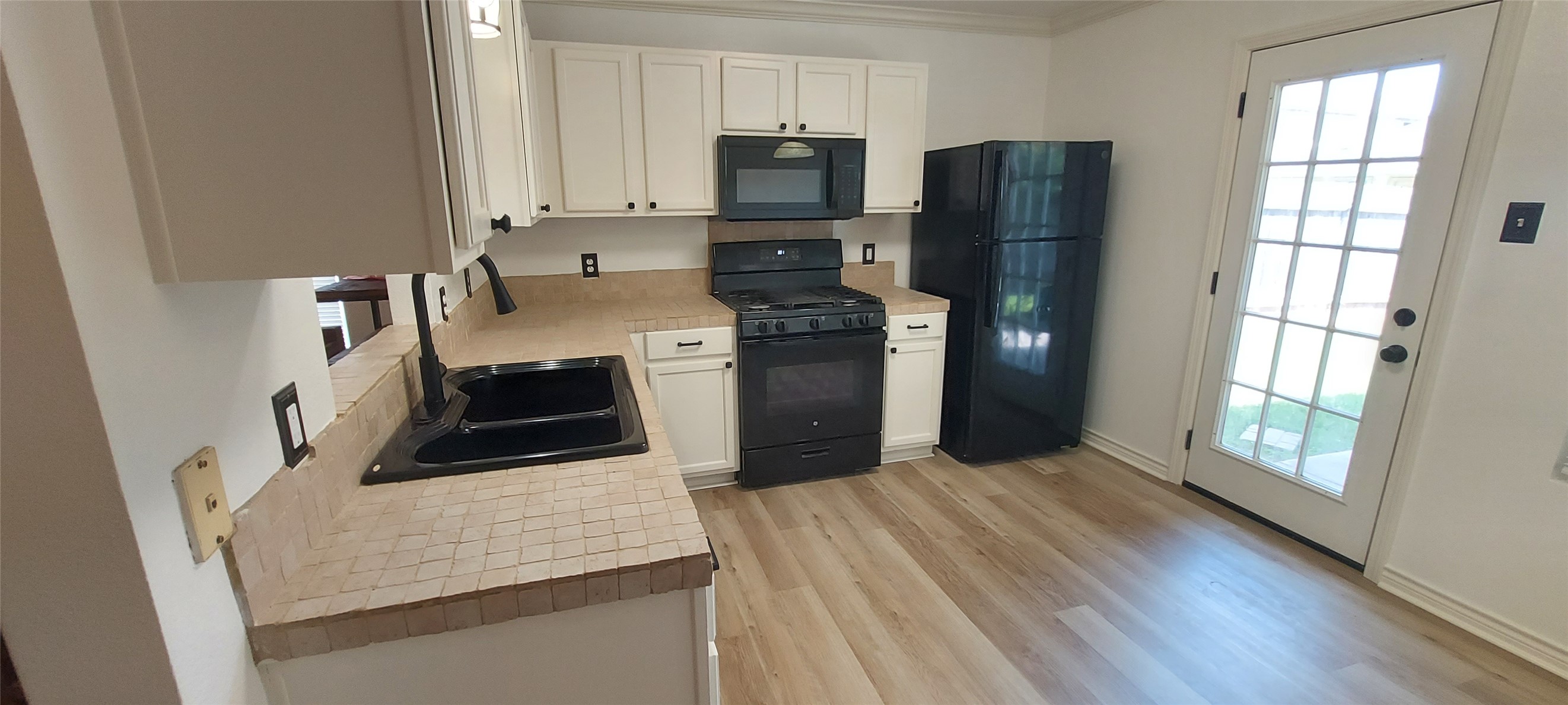 17609 Soapberry Cove Elgin, TX 78621 - Photo 9 of 38 a kitchen with stainless steel appliances granite countertop a refrigerator microwave and sink