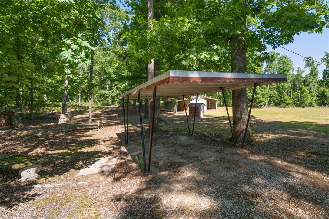304 Shaw Road Honea Path, SC 29654 - Photo 29 of 39 This tranquil outdoor space offers a natural retreat with a dedicated covered parking area.