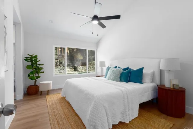 a bathroom with a toilet a sink a mirror and vanity