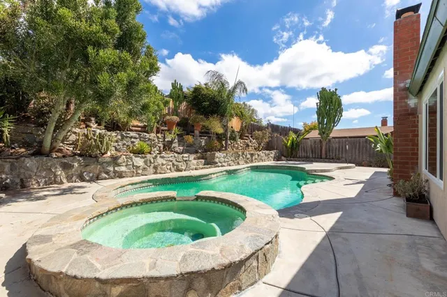 a backyard of a house with table and chairs