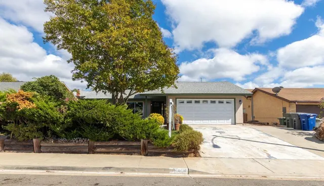 a front view of a house with a garden