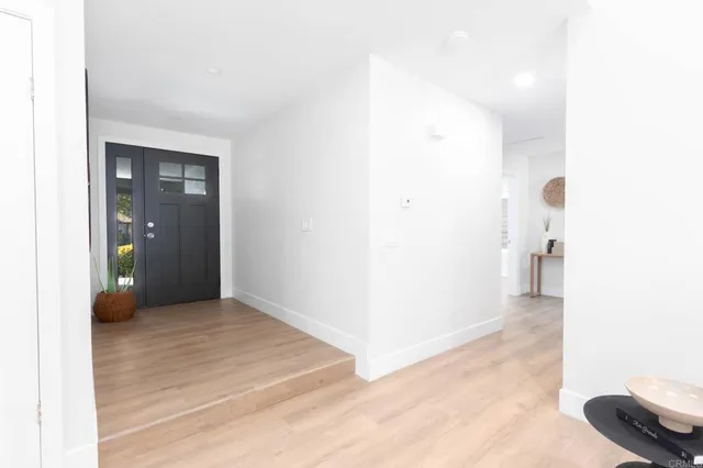 a view of a hallway with wooden floor