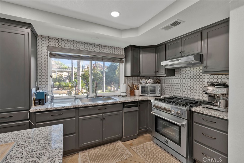 3350 May Court Riverside, CA 92503 - Photo 40 of 55 a kitchen with stainless steel appliances granite countertop a sink and a stove
