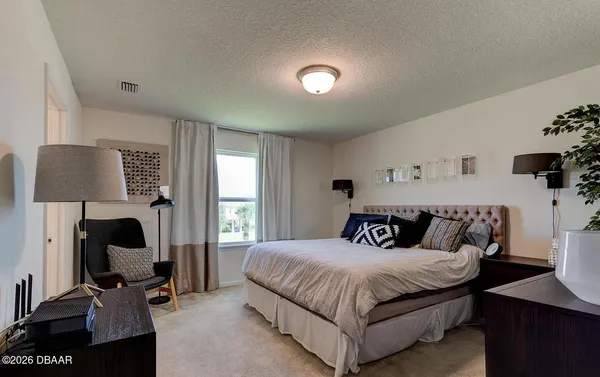 a bedroom with a large bed and a window