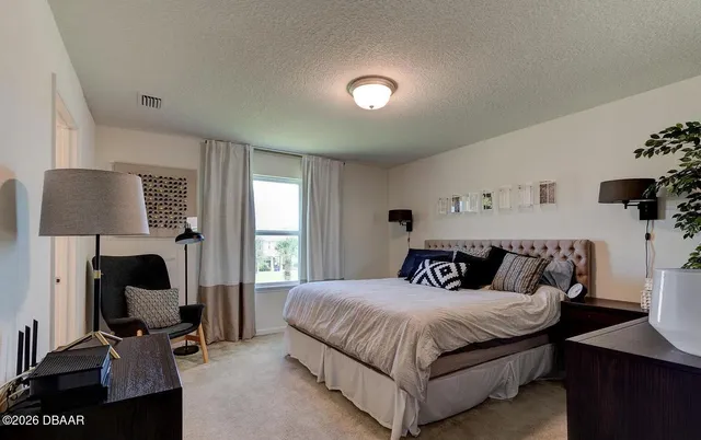 a bedroom with a large bed and a window