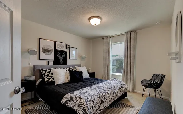 a bedroom with bed and chair