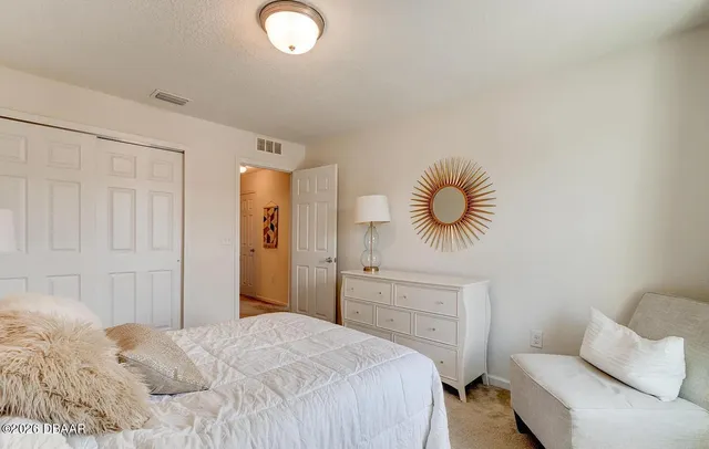 a bedroom with a bed and chandelier
