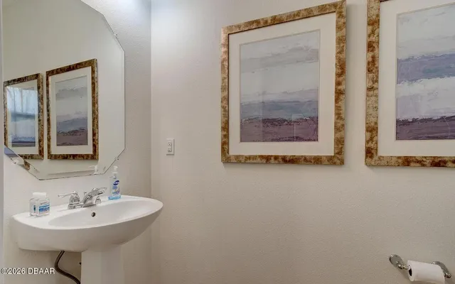 a bathroom with a sink and mirror