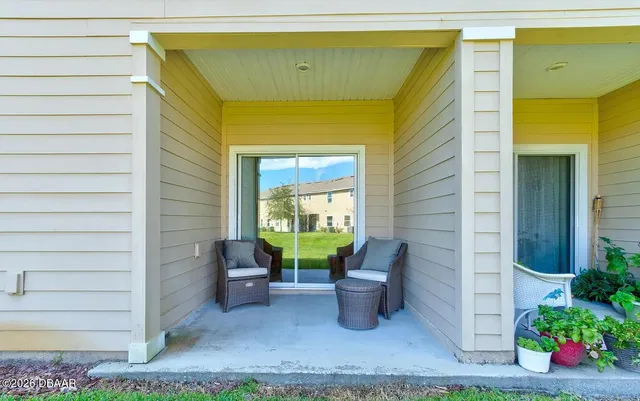 a view of a patio with table and chairs and potted plants