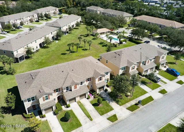 an aerial view of multiple houses with yard