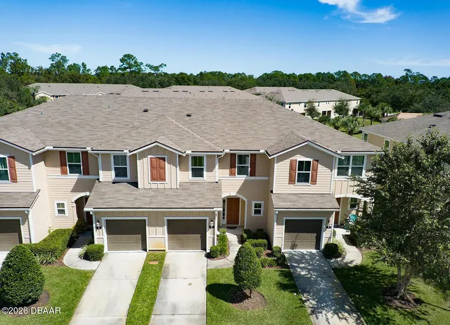 a house that has a tree in front of it