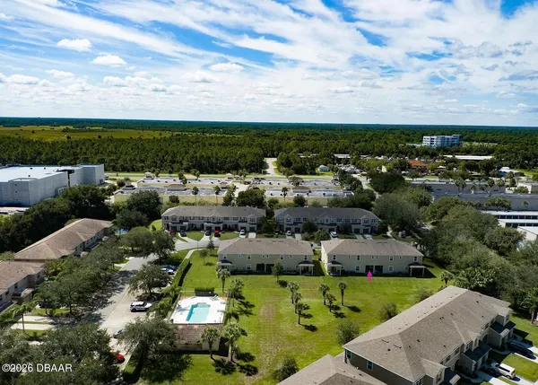 an aerial view of a house with a yard