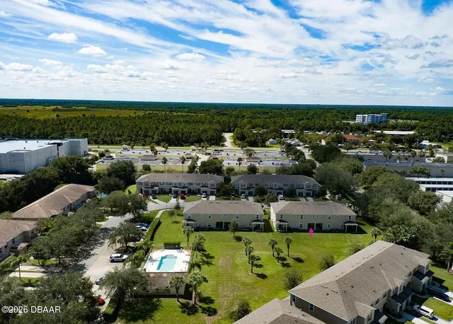 an aerial view of a house with a yard