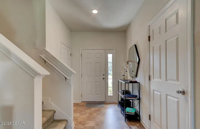 a view of a livingroom with stairs and furniture