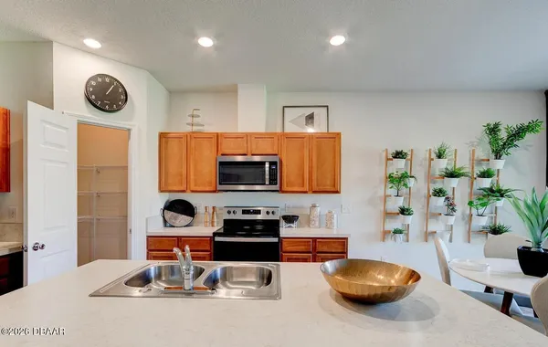 a kitchen with a sink a stove and cabinets