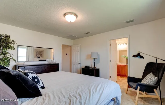 a bedroom with a bed and a chair