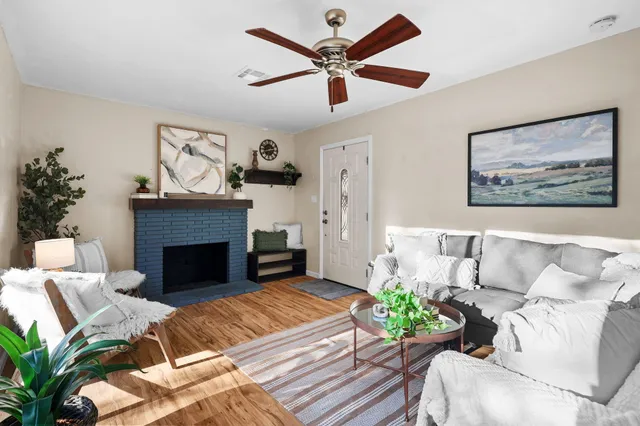 a living room with furniture and a fireplace