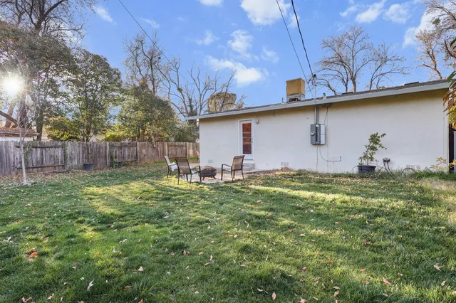 a aerial view of a house with a yard and large tree
