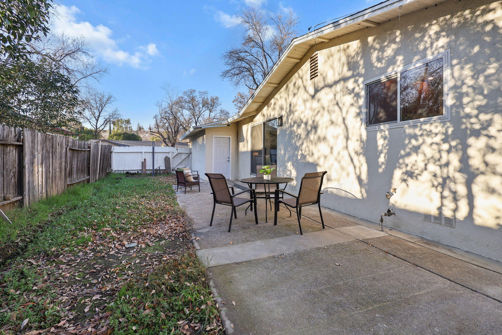 755 Christine Avenue Redding, CA 96003 - Photo 44 of 58 a view of a backyard with table and chairs and a barbeque