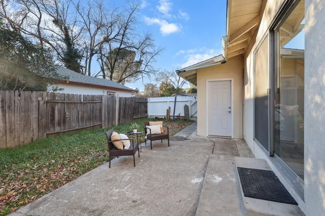 a view of a house with a yard and tree s